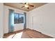 Bright bedroom with a ceiling fan, big window offering outside views, and sliding closet doors at 40108 N 2Nd Way, Phoenix, AZ 85086