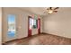 Bright bedroom with outside pool access, ceiling fan, wood flooring, and desert landscape at 40108 N 2Nd Way, Phoenix, AZ 85086