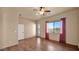 Bright bedroom with outside pool access, ceiling fan, wood flooring, and desert landscape at 40108 N 2Nd Way, Phoenix, AZ 85086