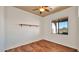 Minimalist bedroom with a ceiling fan, ample window offering outside views, and shelf at 40108 N 2Nd Way, Phoenix, AZ 85086