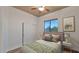 Inviting bedroom featuring an ample window view, sliding closet doors, and neutral decor at 40108 N 2Nd Way, Phoenix, AZ 85086