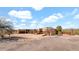 Wide exterior view of a custom home with separate garage, desert landscape, and metal entry gate at 40108 N 2Nd Way, Phoenix, AZ 85086