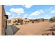 Desert home featuring a sand lot, garage, neutral stucco, and a terracotta-colored roof at 40108 N 2Nd Way, Phoenix, AZ 85086