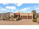 Desert home featuring a sand lot, garage, neutral stucco, and a terracotta-colored roof at 40108 N 2Nd Way, Phoenix, AZ 85086