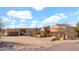 Desert home featuring a sand lot, garage, neutral stucco, and a terracotta-colored roof at 40108 N 2Nd Way, Phoenix, AZ 85086