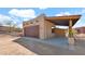 Exterior of the detached garage with covered parking, a roll-up door, and desert landscaping at 40108 N 2Nd Way, Phoenix, AZ 85086