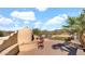 Backyard featuring an outdoor kitchen with pizza oven, grill, and seating, ideal for enjoying the desert scenery at 40108 N 2Nd Way, Phoenix, AZ 85086