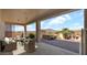 Relax on the covered patio with wicker furniture, a hot tub, and a built-in grill overlooking the desert landscape at 40108 N 2Nd Way, Phoenix, AZ 85086