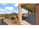 A covered patio offers shade and views of the beautifully landscaped yard and scenic mountain backdrop at 40108 N 2Nd Way, Phoenix, AZ 85086