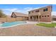 Expansive backyard featuring a refreshing pool, gravel landscaping, and well-maintained synthetic grass at 4098 E Rustler Way, Gilbert, AZ 85297