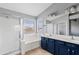 Bright bathroom featuring double sinks, separate tub, and shower stall at 4098 E Rustler Way, Gilbert, AZ 85297