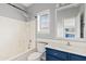 Well-lit bathroom with a shower-tub combo and blue vanity at 4098 E Rustler Way, Gilbert, AZ 85297