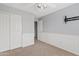 Bedroom with carpet, gray walls, closet with sliding doors and mounted TV at 4098 E Rustler Way, Gilbert, AZ 85297
