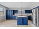Stylish kitchen featuring navy blue cabinets, stainless steel appliances, and an island at 4098 E Rustler Way, Gilbert, AZ 85297