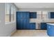 Stylish kitchen featuring navy blue cabinets, stainless steel appliances, and an island at 4098 E Rustler Way, Gilbert, AZ 85297