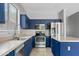 Stylish kitchen featuring navy blue cabinets, stainless steel appliances, and a functional island at 4098 E Rustler Way, Gilbert, AZ 85297