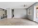 Bright, open living room boasts neutral walls, plush carpet, and sliding glass doors, creating a seamless indoor-outdoor flow at 4098 E Rustler Way, Gilbert, AZ 85297