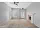 Bright living room with neutral walls, plush carpet, fireplace, and ample natural light streaming through the windows at 4098 E Rustler Way, Gilbert, AZ 85297