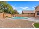 Backyard pool with rock waterfall feature and low-maintenance desert landscaping for easy care at 4098 E Rustler Way, Gilbert, AZ 85297
