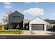 Contemporary home features a unique facade with a mix of dark siding, stone accents, and a well-manicured lawn at 4318 E Cheery Lynn Rd, Phoenix, AZ 85018