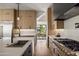 Bright kitchen with stainless steel appliances, modern countertops and faucet, with view to dining area at 4318 E Cheery Lynn Rd, Phoenix, AZ 85018