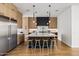 Modern kitchen with custom cabinets, stainless steel appliances, a large island, and stylish pendant lighting at 4318 E Cheery Lynn Rd, Phoenix, AZ 85018