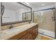 Well-lit bathroom with a double sink vanity and a glass enclosed shower at 4710 E Tierra Buena Ln, Phoenix, AZ 85032