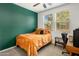 Bright bedroom with an accent wall, a window, and a desk area at 4710 E Tierra Buena Ln, Phoenix, AZ 85032