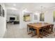 Elegant dining room with a wooden table, modern lighting, and an open view to living area at 4710 E Tierra Buena Ln, Phoenix, AZ 85032