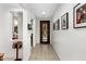 Bright hallway featuring tile floors, white walls, and decorative wall art at 4710 E Tierra Buena Ln, Phoenix, AZ 85032
