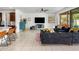 Modern living room with tile floors, plush seating, and media setup at 4710 E Tierra Buena Ln, Phoenix, AZ 85032