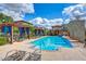 Community pool with blue water, lounge chairs, pergola, and nearby buildings at 4710 E Tierra Buena Ln, Phoenix, AZ 85032