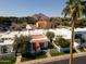 Stunning aerial view of the community with palm trees, red tile roofs, and mountain backdrop at 4836 N 72Nd Way, Scottsdale, AZ 85251