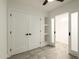 Bedroom with double door closet and built-in shelving with access to an adjacent room at 4836 N 72Nd Way, Scottsdale, AZ 85251
