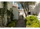 Charming walkway and iron gate surrounded by lush greenery and flowering plants at 4836 N 72Nd Way, Scottsdale, AZ 85251