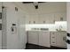 Bright laundry room equipped with appliances, ample counter space, and modern cabinetry at 4836 N 72Nd Way, Scottsdale, AZ 85251