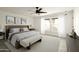 Staged main bedroom is complete with a ceiling fan, neutral toned furniture and natural light at 4836 N 72Nd Way, Scottsdale, AZ 85251