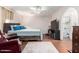 Comfortable bedroom with wood floors, ensuite bathroom, and modern ceiling fan at 4855 W Turquoise Ave, Glendale, AZ 85302