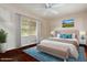 Bright bedroom with hardwood floors, large window, and stylish decor at 4855 W Turquoise Ave, Glendale, AZ 85302
