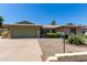 Charming single-story brick home featuring desert landscaping and a spacious two-car garage at 4855 W Turquoise Ave, Glendale, AZ 85302