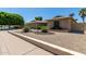 Charming single-story brick home featuring desert landscaping and a spacious two-car garage at 4855 W Turquoise Ave, Glendale, AZ 85302