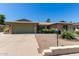 Charming single-story brick home featuring desert landscaping and a spacious two-car garage at 4855 W Turquoise Ave, Glendale, AZ 85302