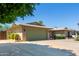 Charming single-story brick home featuring a well-manicured lawn and a spacious two-car garage at 4855 W Turquoise Ave, Glendale, AZ 85302