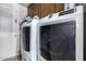 A clean laundry room with modern, matching, high-efficiency, front-loading washer and dryer at 4855 W Turquoise Ave, Glendale, AZ 85302