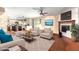 Bright and airy living room with plush seating, fireplace, and seamless transition to the modern kitchen at 4855 W Turquoise Ave, Glendale, AZ 85302