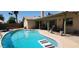 Backyard pool with diving board and patio area, creating a perfect space for outdoor entertainment at 4855 W Turquoise Ave, Glendale, AZ 85302