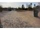 A vacant lot with a gravel driveway and trash can, awaiting new construction or landscaping project at 502 E Roeser Rd, Phoenix, AZ 85040