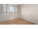 Well-lit bedroom with wood-look floors and a large window at 5339 N Black Canyon Hwy, Phoenix, AZ 85015