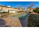 Community shuffleboard area surrounded by lawns, trees, and unit exteriors at 5339 N Black Canyon Hwy, Phoenix, AZ 85015