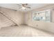 Bright living area with tile floors, ceiling fan, stairs, and a view to the outside at 5339 N Black Canyon Hwy, Phoenix, AZ 85015